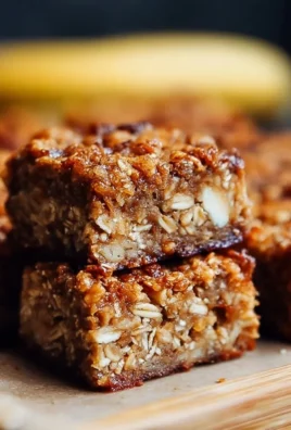 Delicious homemade banana oatmeal bars on a wooden table.