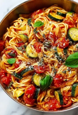 Delicious bowl of homemade tomato zucchini pasta with fresh herbs