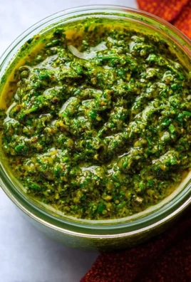 Homemade chermoula paste in a bowl with fresh herbs and spices.