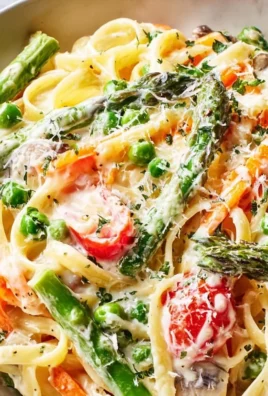 Creamy Pasta Primavera with colorful vegetables in a bowl.