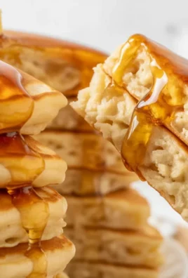 Stack of fluffy pancakes with butter and syrup, perfect for breakfast recipes.