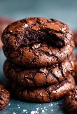 Plate of gourmet brownie cookies drizzled with chocolate sauce.