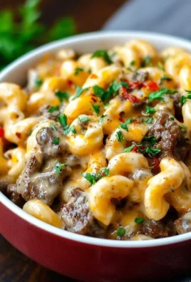 High-protein creamy Philly cheesesteak mac and cheese topped with juicy beef and melted cheese