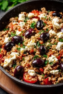 Mediterranean Keto Chicken Skillet with olives and feta in a cast iron pan