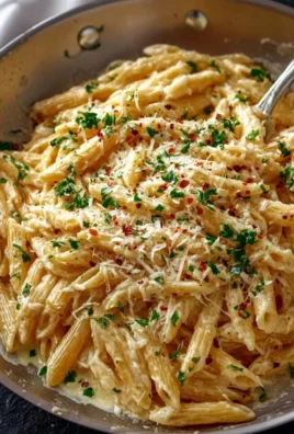 Delicious one pot creamy garlic pasta served in a bowl with herbs.