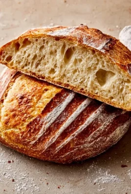 Freshly baked sourdough bread on a wooden cutting board