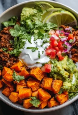 Colorful Sweet Potato Taco Bowl topped with avocado and cilantro