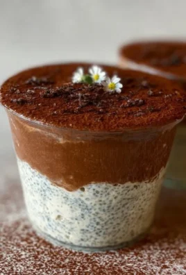 Viral tiramisu chia pudding in a glass with coffee beans and cocoa powder on top