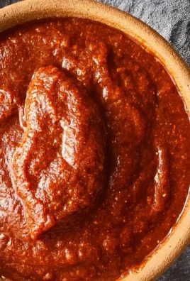 Homemade red enchilada sauce in a bowl with fresh ingredients