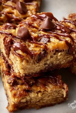 Four ingredient peanut butter banana bars on a wooden table