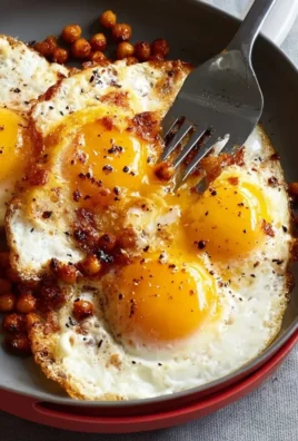 Chickpea fried eggs served with fresh vegetables on a plate.