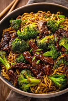 Delicious bowl of Chinese crispy beef and broccoli noodles