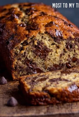 Delicious chocolate chip banana bread sliced on a wooden cutting board