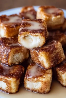 Delicious cinnamon roll French toast bites topped with icing and berries