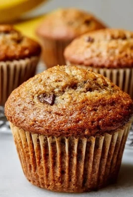 Freshly baked moist banana bread muffins on a rustic wooden table
