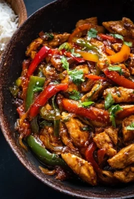 Pepper Chicken Stir-Fry with vibrant vegetables and spices in a pan.