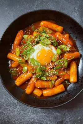 Delicious spicy rice cakes served garnished with vegetables and sauce