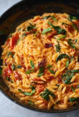 Tomato Spinach Bacon Orzo with fresh ingredients and vibrant colors