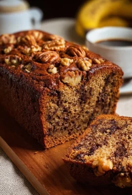 Delicious slice of ultimate banana nut bread topped with walnuts