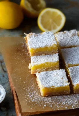 Delicious homemade lemon bars topped with powdered sugar