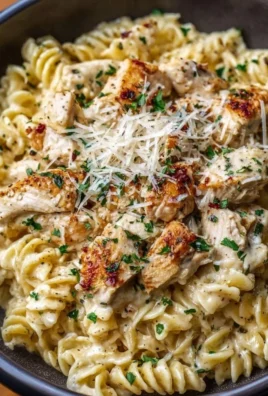 Crockpot Garlic Parmesan Chicken Pasta with fresh herbs and creamy sauce