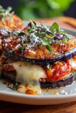 Layered Eggplant Napoleon with mozzarella and basil on a plate
