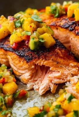 Plate of fresh salmon fillet garnished with mango salsa