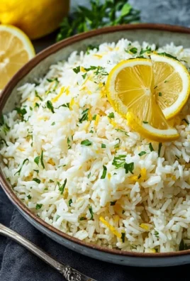 Bowl of Greek Lemon Rice garnished with herbs and lemon slices