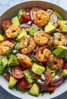 Healthy shrimp avocado salad served in a bowl with fresh ingredients