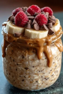 High-protein peanut butter overnight oats topped with nuts and berries