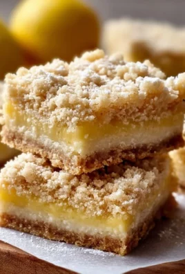 Delicious homemade lemon crumb bars on a plate with crumbs scattered