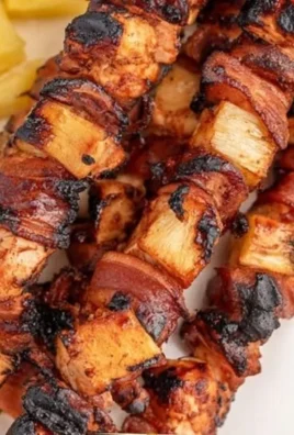 BBQ chicken bacon pineapple kabobs on a grill platter