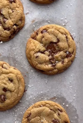Freshly baked chocolate chip cookies on a cooling rack