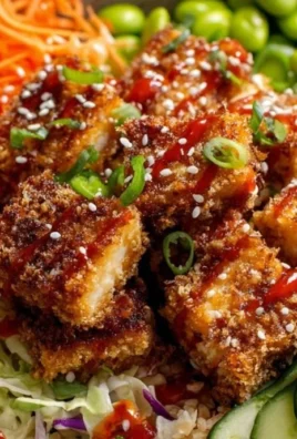 Coconut Crusted Tofu Bowl with fresh vegetables and a vibrant sauce