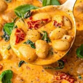 Creamy Greek Yogurt Marry Me Butter Beans dish garnished with herbs.