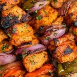 Grilled chicken kabobs with colorful vegetables on skewers.