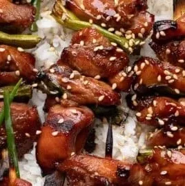 Grilled teriyaki chicken skewers served on a platter
