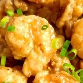Plate of Honey Walnut Shrimp with crispy shrimp and walnuts in creamy sauce.