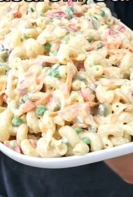 Creamy macaroni salad served in a bowl with vegetables
