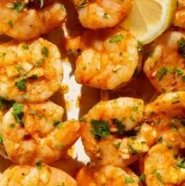 Oven baked shrimp skewers with herbs and spices on a grill pan