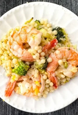Delicious Parmesan Couscous with Shrimp and Broccoli served in a bowl