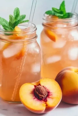 Delicious glass of homemade Peach Lemonade with fresh peaches and mint
