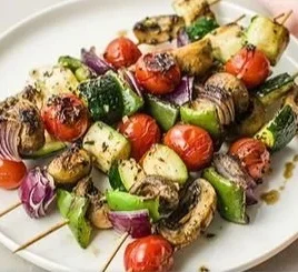 Colorful roasted vegetable kebabs with peppers, zucchini, and mushrooms on skewers