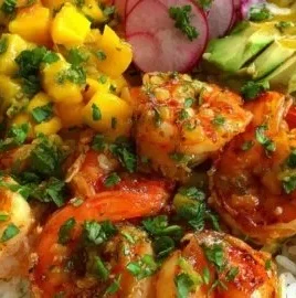 Shrimp and avocado bowl topped with mango salsa and lime-chili sauce