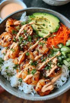 Shrimp rice bowls with spicy mayo on a colorful plate
