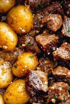 Slow Cooker Garlic Butter Beef Bites with Potatoes in a serving bowl