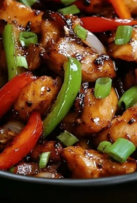 Delicious sweet chili chicken dish served with vibrant garnishes