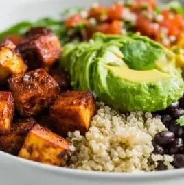 High protein vegan burrito bowl filled with colorful vegetables and grains.