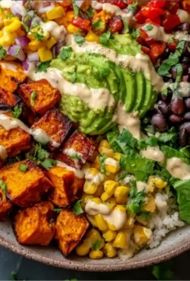 Vegan sweet potato burrito bowl filled with colorful vegetables and spices