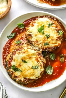 Air Fryer Eggplant Parmesan dish served in a bowl, garnished with basil